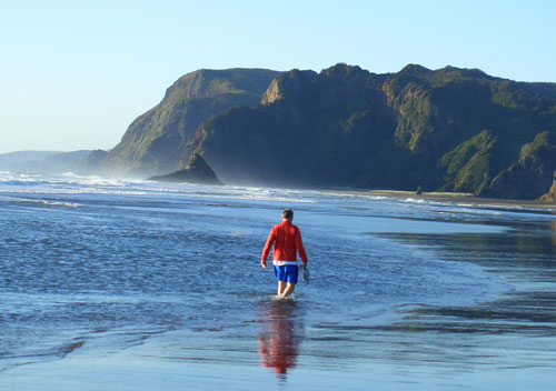 The author wading in the shallows of Karekare